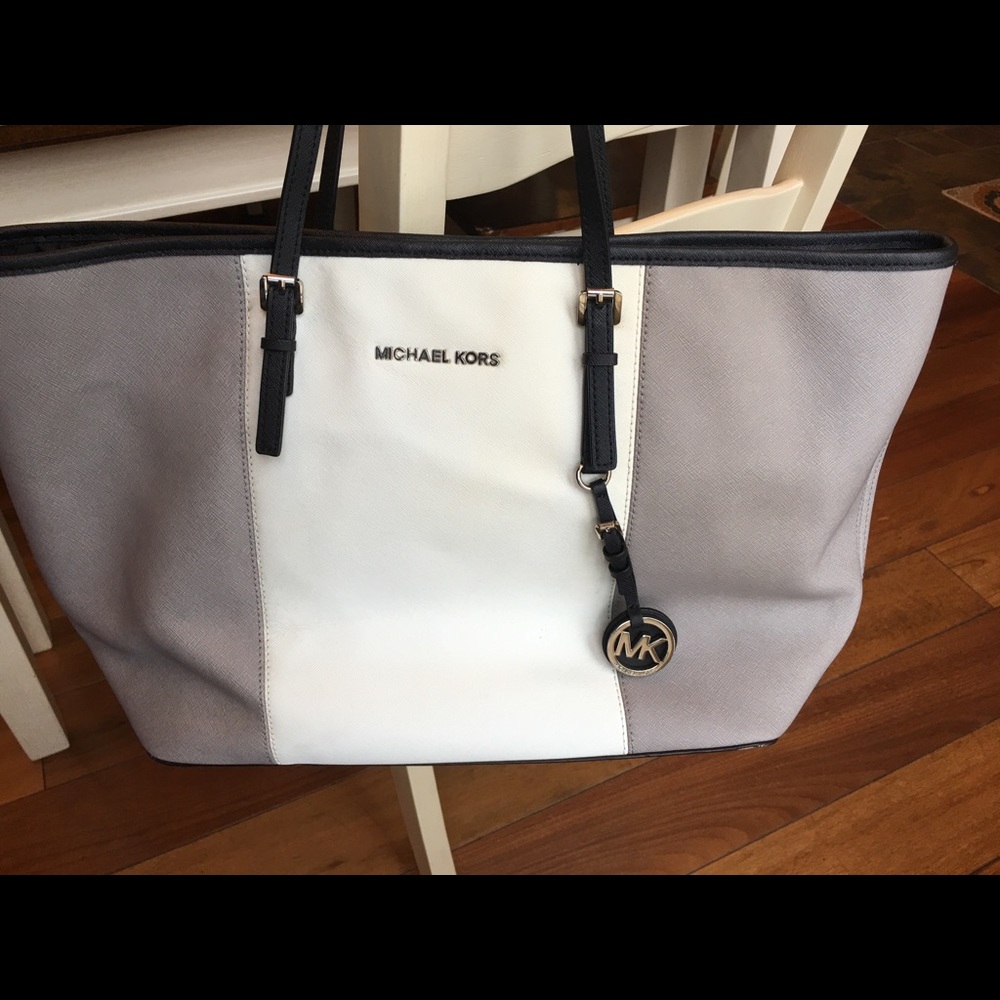 Grey, white, and black Michael Kors tote
